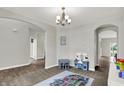 Bright playroom area with hardwood floors, a toy kitchen set, and gray carpet at 7319 Farlin Dr, Whitestown, IN 46075