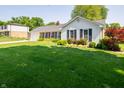 Well-maintained home with lush front lawn, landscaping, and traditional shutters at 7450 Cotherstone Ct, Indianapolis, IN 46256