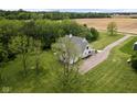 A high aerial view of a beautiful home surrounded by trees, showing the driveway and landscaped grounds at 8555 S County Road 375 E, Mooresville, IN 46158