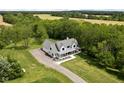 Stunning aerial view of a two-story home surrounded by lush greenery and a long driveway leading to the house at 8555 S County Road 375 E, Mooresville, IN 46158