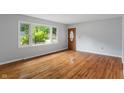 Bright and airy living room showcasing gleaming hardwood floors and abundant natural light at 895 W Poplar St, Zionsville, IN 46077