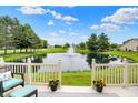 Relaxing backyard view featuring a scenic pond with a fountain at 896 Fairfield Dr, Greenfield, IN 46140