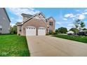 Beautiful two-story brick home with a spacious driveway and well-manicured lawn at 9717 Chuckwalla Pl, Fishers, IN 46040