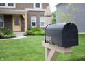 Close-up of a mailbox in front of a home, with a well-kept lawn and a view of the house at 9903 Deep Royal Way, Indianapolis, IN 46239