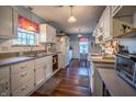 Well-lit kitchen featuring white cabinetry, laminate countertops and stainless-steel sink with views from the window at 1052 Barley Cir, Carmel, IN 46032
