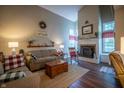 Cozy living room with fireplace, wood floors, a comfortable sofa, and plenty of natural light at 1052 Barley Cir, Carmel, IN 46032