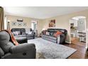 Spacious living room with neutral walls, plush seating, and elegant area rug on hardwood floors at 10854 E 700 N, Wilkinson, IN 46186