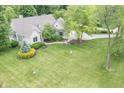 Aerial view of the home showing the large yard, mature trees and landscaping at 11020 Florida Rd, Fortville, IN 46040