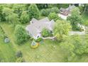 An aerial view showcasing a home with its manicured lawn, mature trees, and serene surroundings at 11020 Florida Rd, Fortville, IN 46040