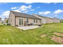 Large, open backyard with a concrete patio and room for recreation and relaxation at 123 Campus Ln, Greenwood, IN 46143
