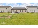 Spacious, grassy backyard featuring a concrete patio perfect for outdoor dining at 123 Campus Ln, Greenwood, IN 46143