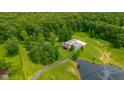 A home with a pond and acreage surrounded by dense green trees at 12383 S 25 W, Columbus, IN 47201