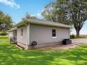 Rear view of gray sided home showing vinyl siding and well maintained yard at 12508 N Jackley Rd, Elwood, IN 46036