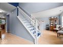 Inviting foyer with a staircase featuring blue accents and light hardwood flooring at 12624 Majestic Way, Fishers, IN 46037