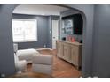 Comfortable living room with large window, gray walls, hardwood floors, and a modern couch at 1331 N Berwick Ave, Indianapolis, IN 46222