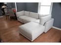 Cozy living space with a sectional couch, hardwood floors and view into the dining area at 1331 N Berwick Ave, Indianapolis, IN 46222