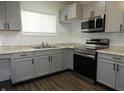 Modern kitchen with stainless steel appliances, granite countertops and grey cabinets at 1352 W 22Nd St, Indianapolis, IN 46202