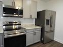 Well-equipped kitchen featuring stainless steel appliances and stylish gray cabinetry at 1352 W 22Nd St, Indianapolis, IN 46202
