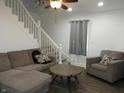Cozy living room featuring comfortable seating, a ceiling fan, and stylish hardwood flooring at 1352 W 22Nd St, Indianapolis, IN 46202