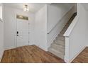 Inviting foyer features wood flooring, a staircase with carpet runner, and a front door at 14878 E Keenan Cir # Lot 37, Westfield, IN 46074