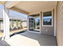 Covered patio with gray siding, white support beams, and sliding glass door access at 14878 E Keenan Cir # Lot 37, Westfield, IN 46074