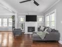 Bright living room with modern gray furnishings, fireplace, and gleaming hardwood floors at 1617 E 52Nd St, Indianapolis, IN 46205