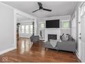 Bright living room with modern gray furnishings, fireplace, and gleaming hardwood floors at 1617 E 52Nd St, Indianapolis, IN 46205