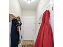 Cozy hallway with coat rack and white door, offering a welcoming entrance into the home at 17233 Gunther Blvd # 102B, Westfield, IN 46074