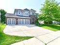 Attractive two-story home featuring a spacious three-car garage, brick detailing, and green lawn at 18726 Tillamook E Run, Noblesville, IN 46062