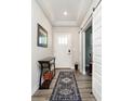 Inviting entryway with stylish runner rug, modern light fixtures, and convenient sliding barn door at 19581 Sumrall Pl, Westfield, IN 46074