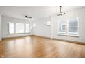 Spacious living room with hardwood floors, a ceiling fan, and large windows for natural light at 19987 Old Dock Rd, Westfield, IN 46074