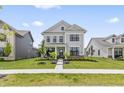 Inviting two-story home boasts a well-maintained lawn and classic architectural details at 2223 Ryder Pl, Westfield, IN 46074