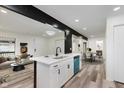 Open-concept living space with a view of a modern kitchen, dining area, and comfortable living room at 233 N Devon Ave, Indianapolis, IN 46219