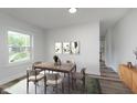 Bright dining room with modern table and chairs near large window at 2531 E Brookside Ave, Indianapolis, IN 46218