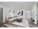 Bright living room features neutral decor, modern lighting, and an area rug at 2631 Collier St, Indianapolis, IN 46241