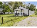 The rear of this single-story home has an enclosed yard with an easy-to-maintain gravel driveway at 2631 Collier St, Indianapolis, IN 46241