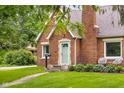 Close up of a brick home featuring a quaint entryway, tidy lawn, and inviting outdoor seating area at 2645 Washington St, Columbus, IN 47201