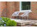 Comfortable outdoor seating area with stylish chairs, a small table, and beautiful landscaping at 2645 Washington St, Columbus, IN 47201