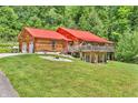 Stunning log home with a red metal roof, garage, and beautifully landscaped yard at 2780 W Grizzly Trl, Martinsville, IN 46151
