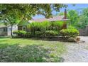 Landscaped front yard with brick exterior, shingle roof, and green trimmed house at 2905 N Warman Ave, Indianapolis, IN 46222