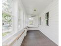 Bright sunroom with white shiplap and many windows at 3035 N Capitol Ave, Indianapolis, IN 46208