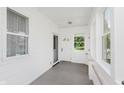 Well-lit porch with many windows, shiplap, and indoor-outdoor carpet at 3035 N Capitol Ave, Indianapolis, IN 46208