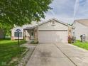 Charming home featuring a two-car garage, long driveway, landscaped front yard, and a lovely mix of siding and brick at 3223 Keystone Lakes Way, Indianapolis, IN 46237