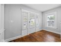 Bright living room featuring hardwood floors, large windows, and fresh paint at 3227 Guilford Ave, Indianapolis, IN 46205