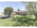 Attractive single-story home with a well-maintained lawn and mature trees at 407 N Matthews Rd, Greenwood, IN 46143