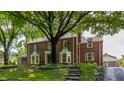 Beautiful brick home with mature landscaping and a private driveway at 5165 E Pleasant Run Pkwy S Dr, Indianapolis, IN 46219
