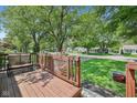 Spacious front porch with a charming wooden railing, potted flowers, and a view of the tree-lined street at 5333 Ralston Ave, Indianapolis, IN 46220