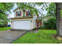 Charming two-story home with red shutters, attached two car garage, and a well maintained lawn at 5369 Red River Ct, Indianapolis, IN 46221
