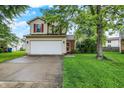 Charming two-story home with red shutters, attached two car garage, and a well maintained lawn at 5369 Red River Ct, Indianapolis, IN 46221