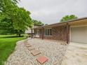 Close-up of the front of the house, showing the stone walkway, brick accents, and inviting entrance at 5542 N Olivia Dr, Alexandria, IN 46001
